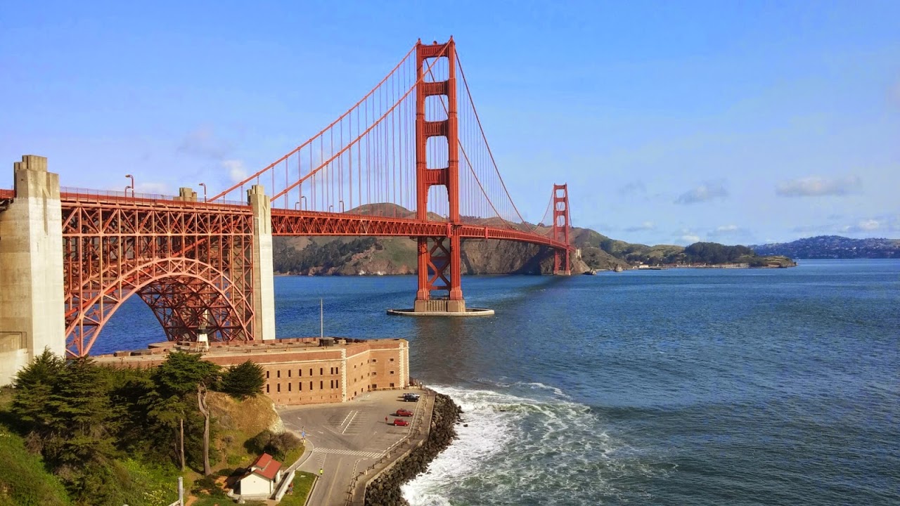 Golden Gate Bridge iconic red towers spanning San Francisco Bay against blue sky